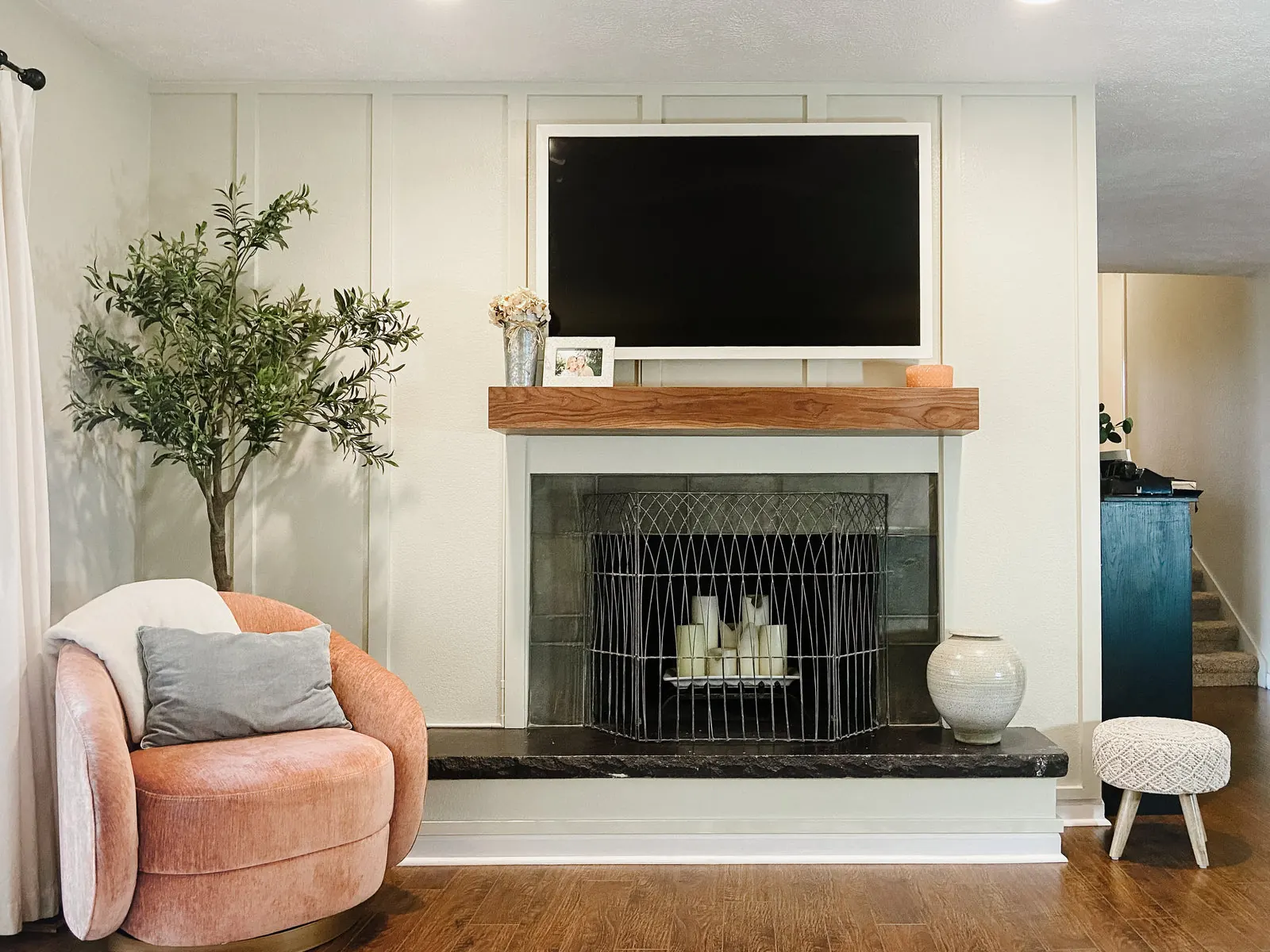 A styled living room with a floating mantel under the television and warm seating. Photo from ultrashelf.com.