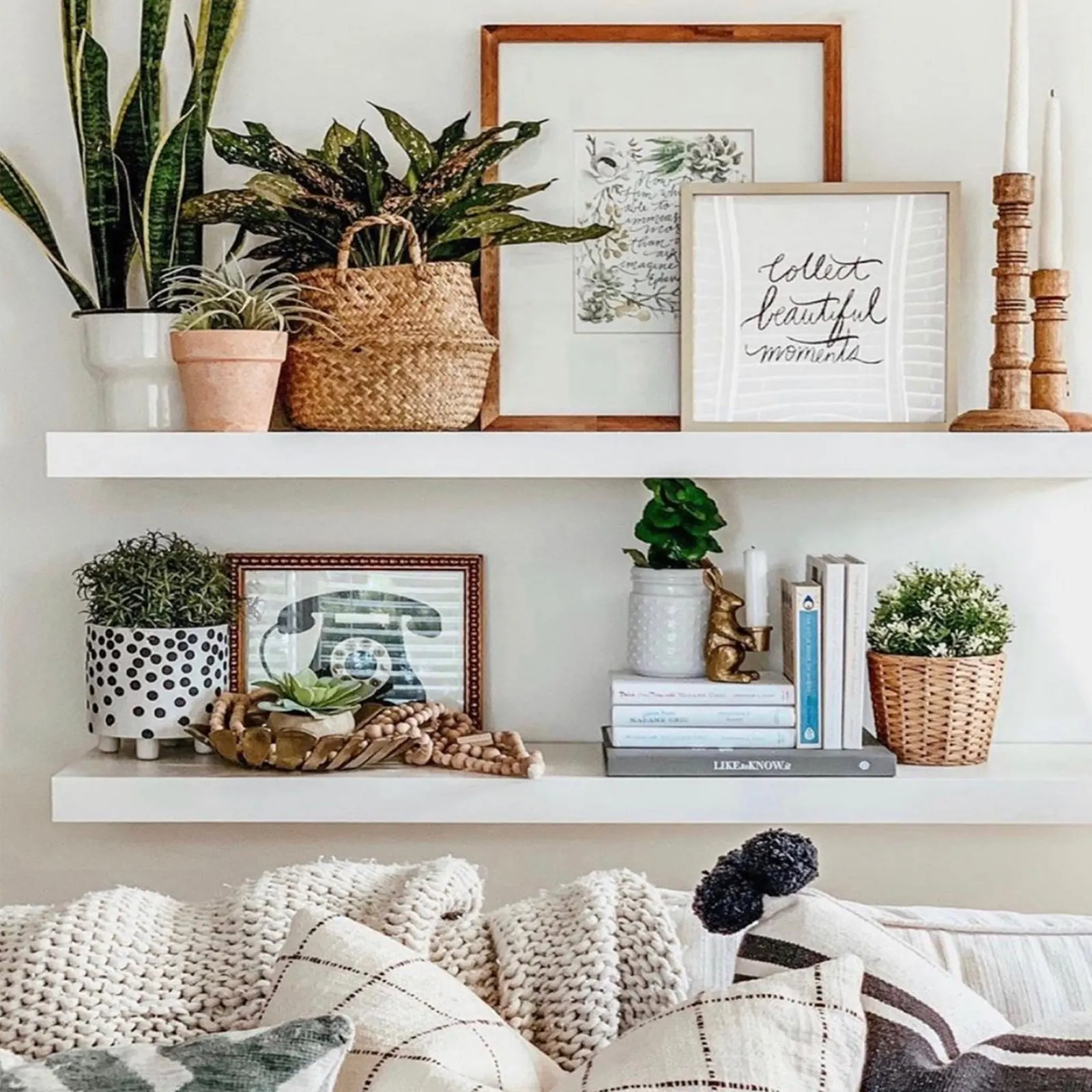 Layered picture ledges styled with art, plants, and books in a cozy living room. Photo from ultrashelf.com.